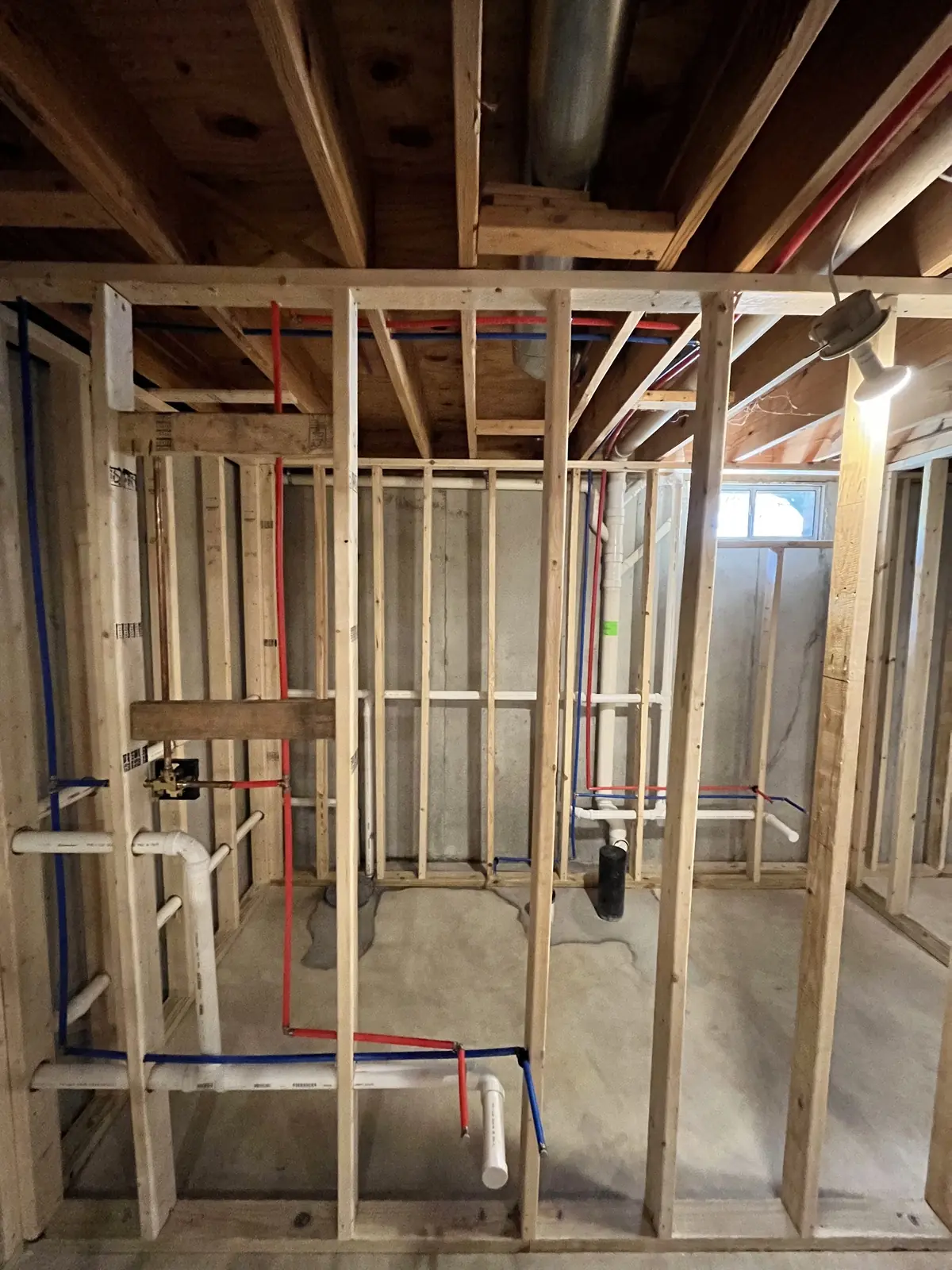Bathroom rough-in with framed walls and new water and drain lines