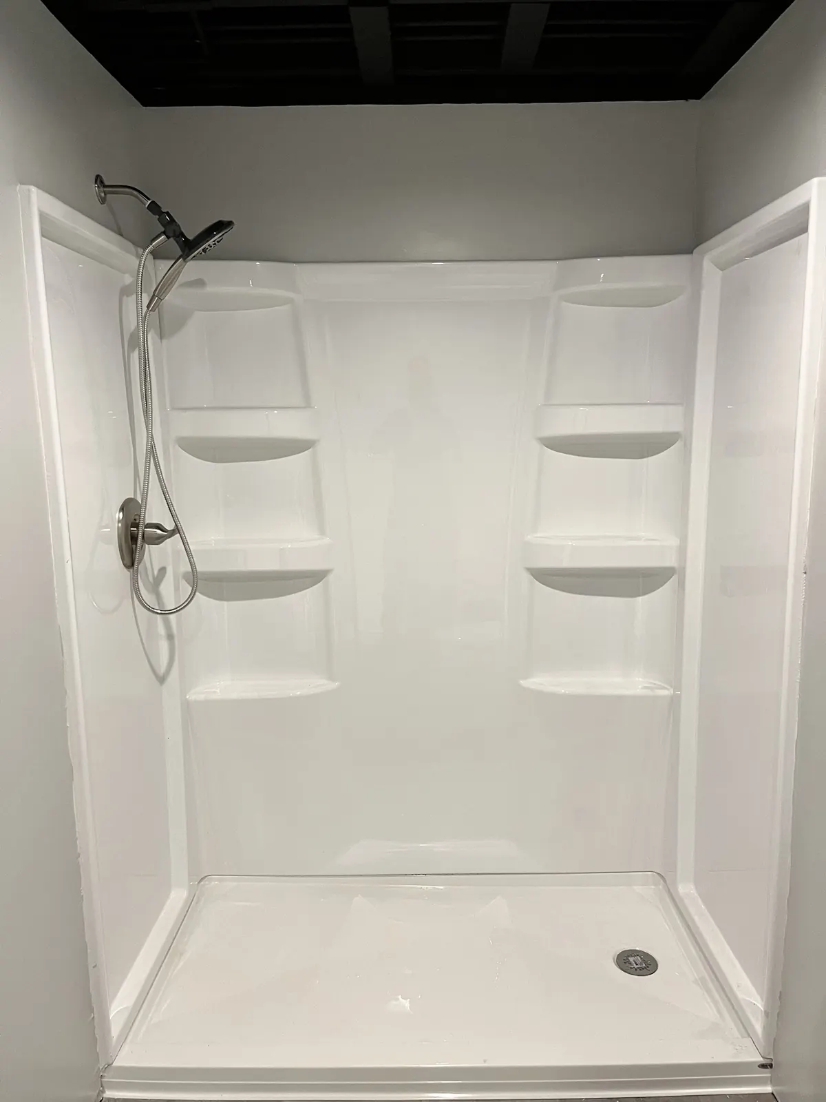 New white shower surround with built-in shelves
