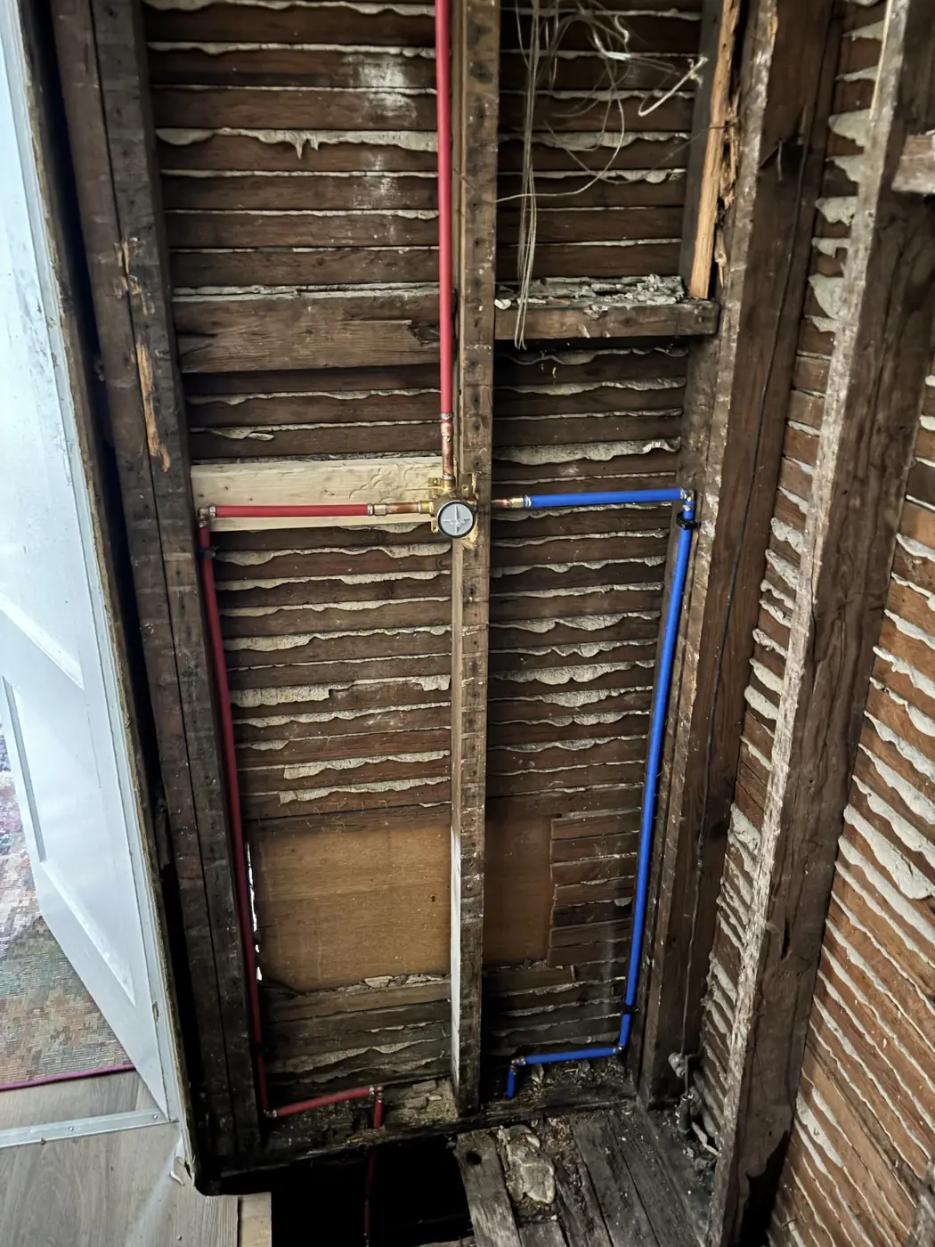 New hot and cold water lines run inside an open wall